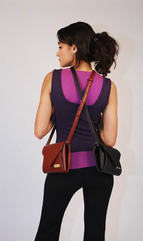 dark hair girl wearing burgundy and black kaila katherine vegan leather brixton clutch shoulderbags