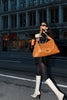 girl on street holding tan kaila katherine vegan leather boho bag