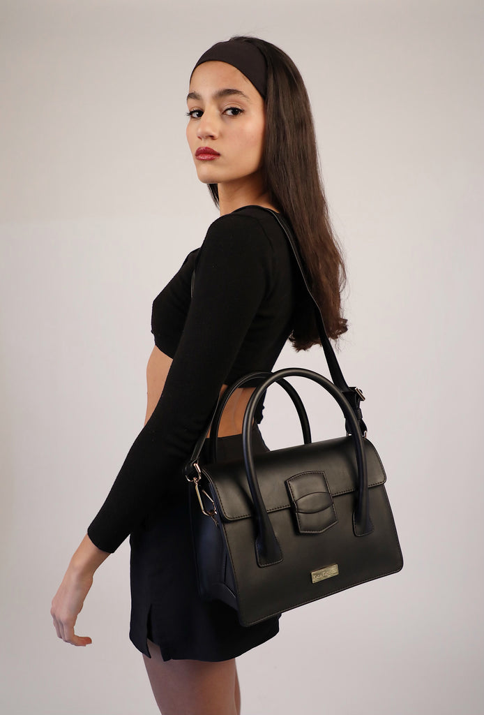 long dark haired girl wearing black kaila katherine vegan leather handbag