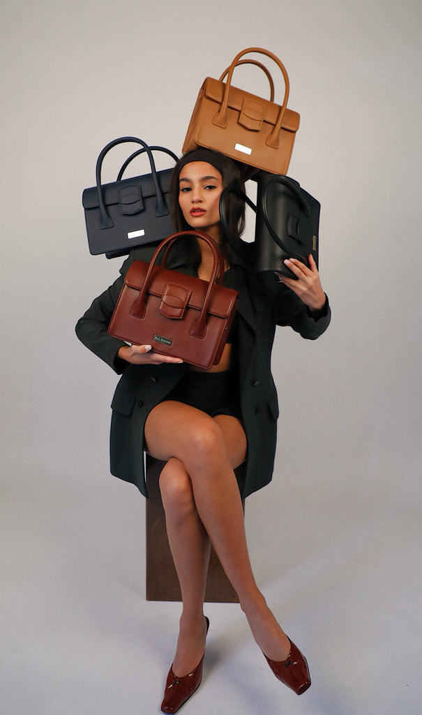 girl holding kaila katherine vegan leather kensington handbags tan, burgundy, and black